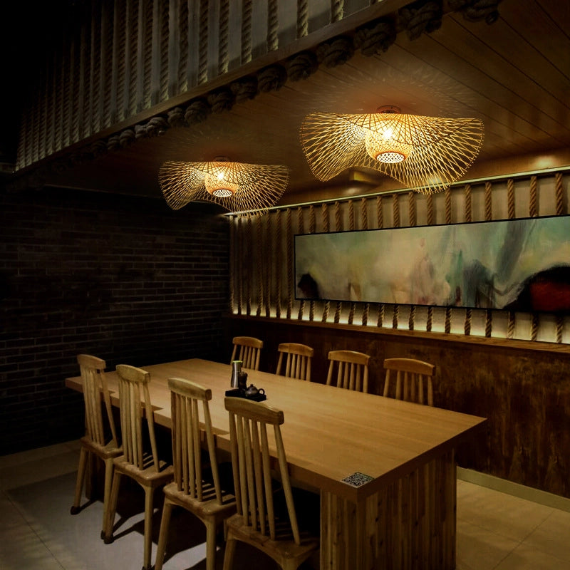 Bamboo Wave Ceiling Lamps: Woven bamboo lights with curved design, casting warm patterns in a rustic dining space.
