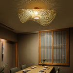 Bamboo Wave Ceiling Lamp: Woven bamboo light with curved design, casts warm patterns in Japanese-style dining room.