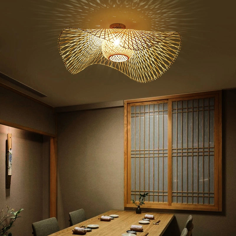 Bamboo Wave Ceiling Lamp: Woven bamboo light with curved design, casts warm patterns in Japanese-style dining room.