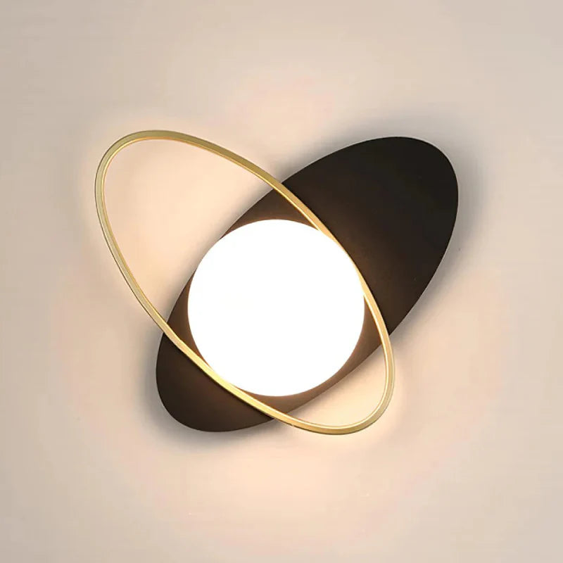 A modern Galaxy Wall Lamp with a unique design of a white glass sphere and a gold ring.