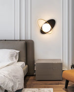 The Galaxy Wall Lamp combining a black backing and a bright white lampshade.