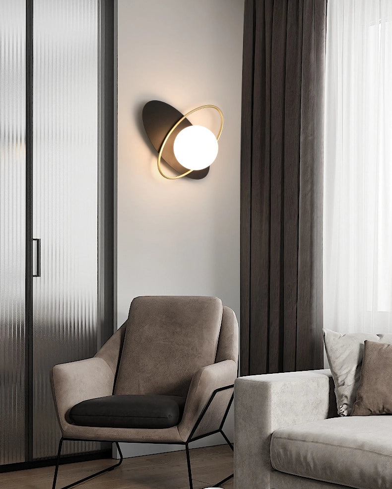 An elegant Galaxy Wall Lamp with a round white glass part and a golden accent.