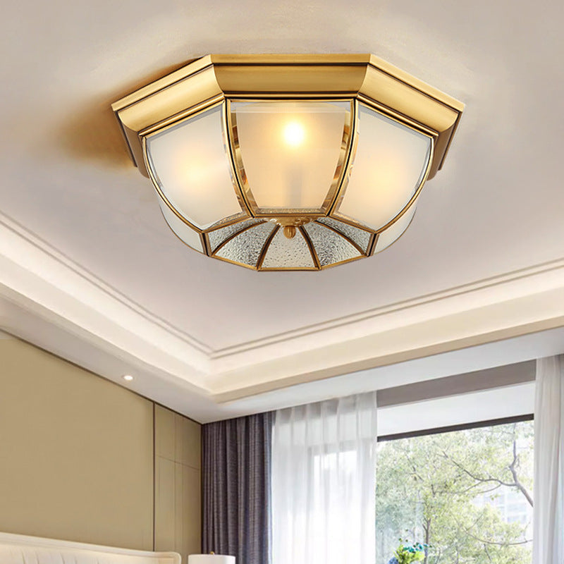 brass bowl ceiling lamp with octagonal brass frame and mixed frosted glass, mounted on ceiling beside bedroom sheer curtains
