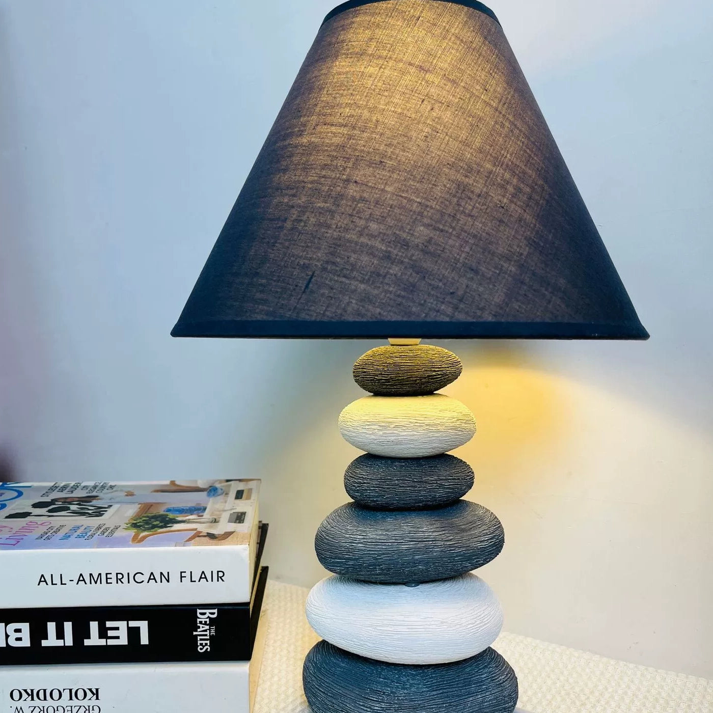 Eco-friendly ceramic table lamp with a rugged stone texture and earth-toned illumination.