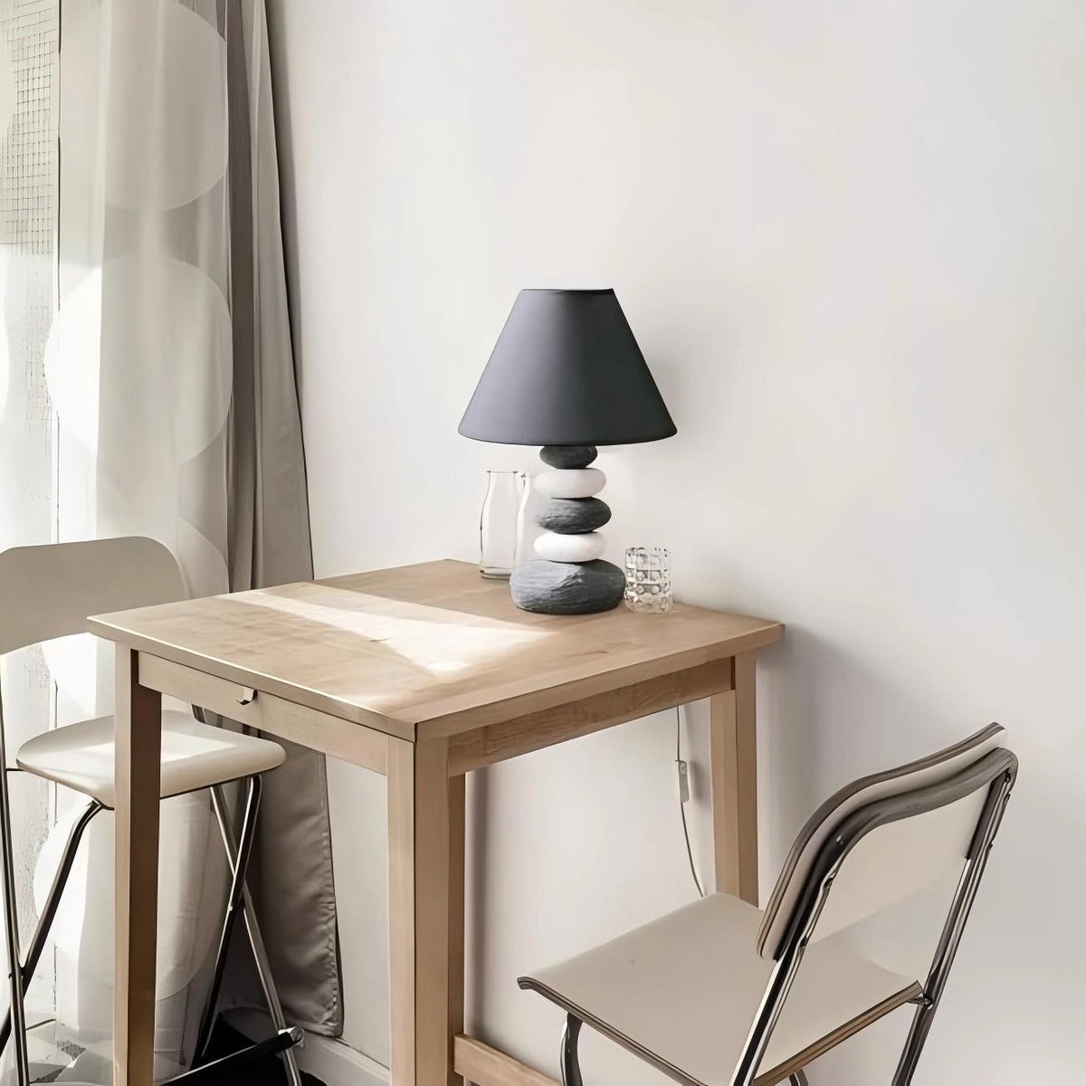 Scandinavian-style ceramic table lamp with a matte stone finish and subtle lighting accents.