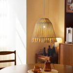 A small hemp rope pendant lamp hangs low over the tea table