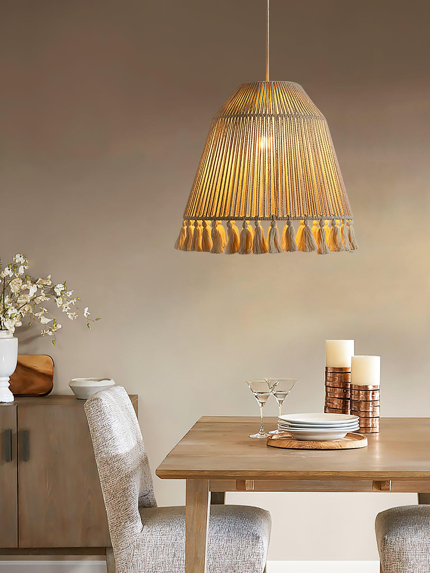 The height-adjustable tassel pendant light illuminates the corner of the dining table