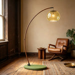Contemporary Arc Floor Lamp with Glass Shade by vintage leather armchair, curved wood arm for retro living room standing light