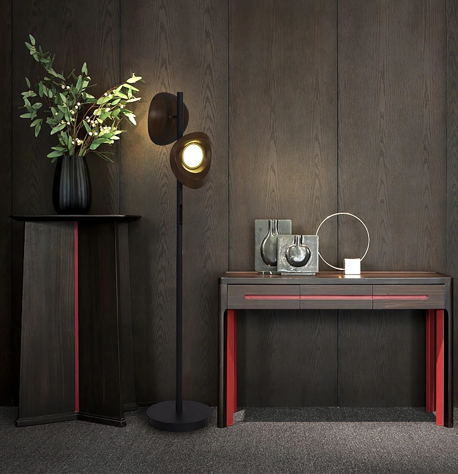 A floor lamp with two wooden lampshades stands in front of a wooden wall