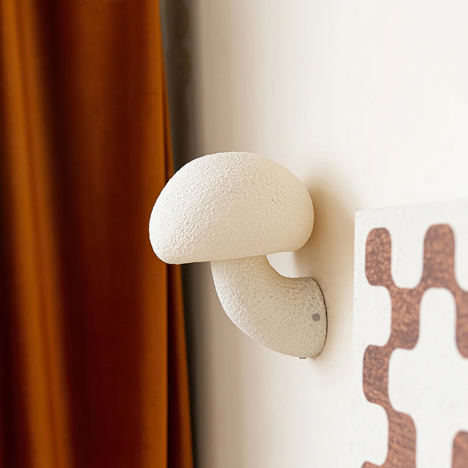 Close up of resin mushroom wall lamp installed in the corner of the wall