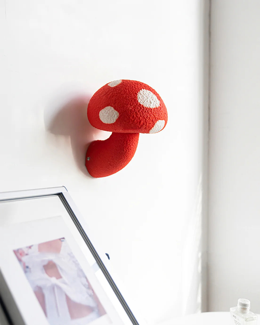 The red mushroom wall lamp with a lamp body is very eye-catching in modern spaces