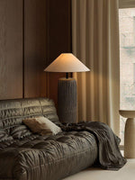 The floor lamp creates a quiet atmosphere in the corner of the floor-to-ceiling window.