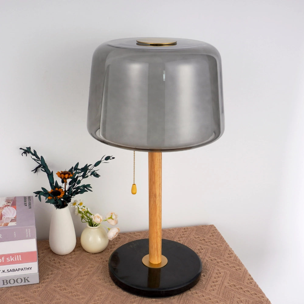 Table lamp with marble base and smoked glass shade decorates the modern living room