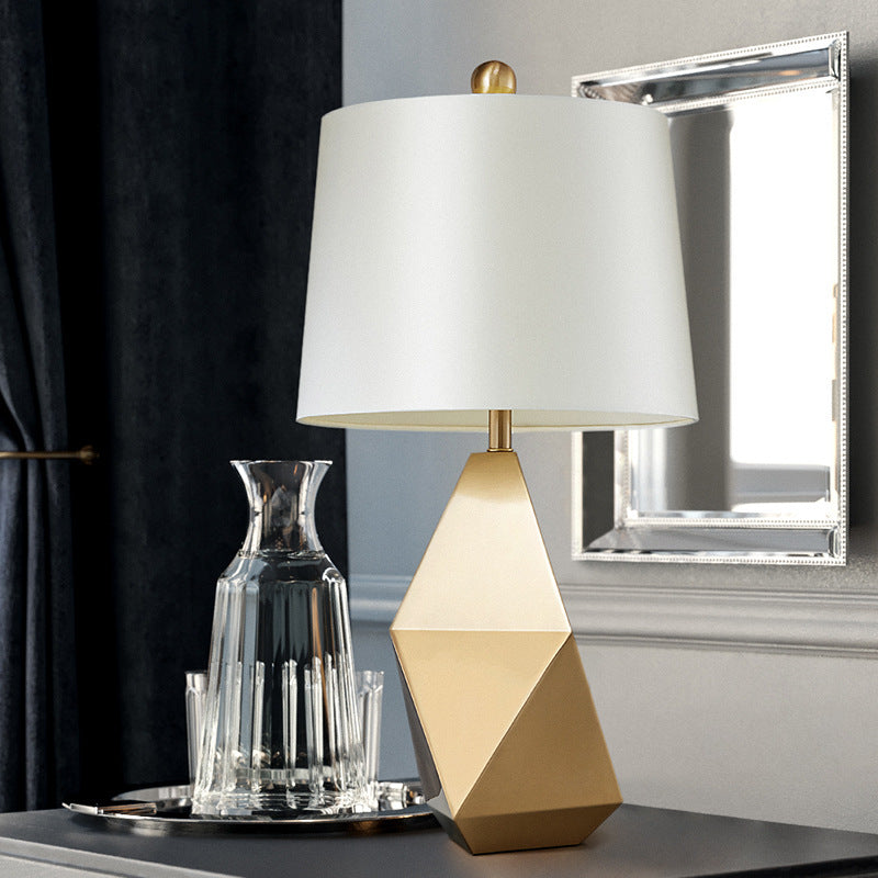 Table lamp with white fabric lampshade and wine glass together