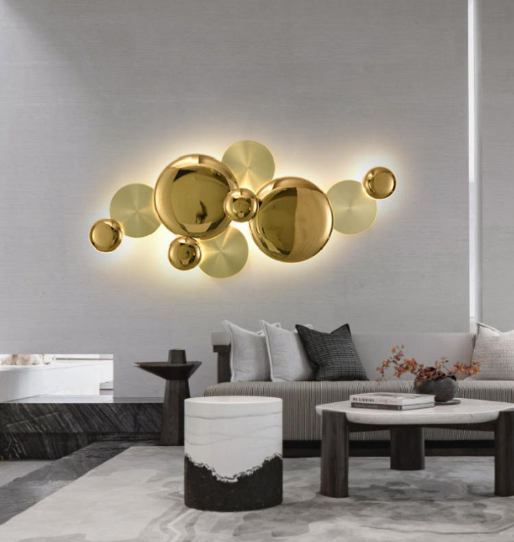 The multi-circle wall lamp illuminates the modern living room at night