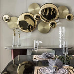 The atmospheric Forart Metal Wall Lamp is on the white wall behind the dining table