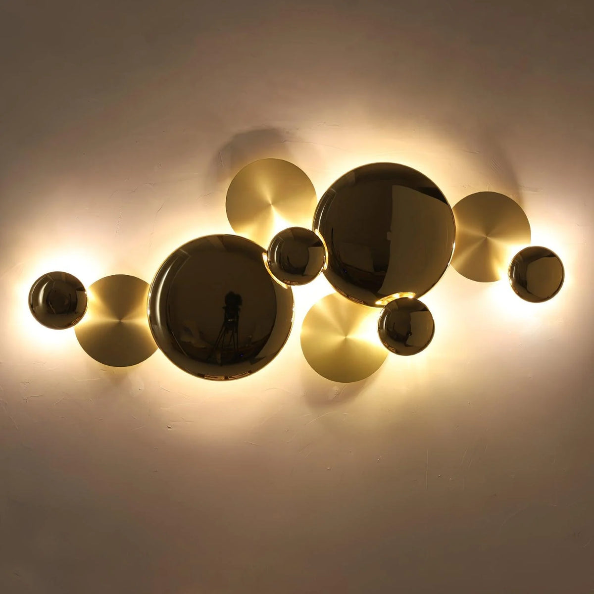 Metal disc wall lamp in the dark