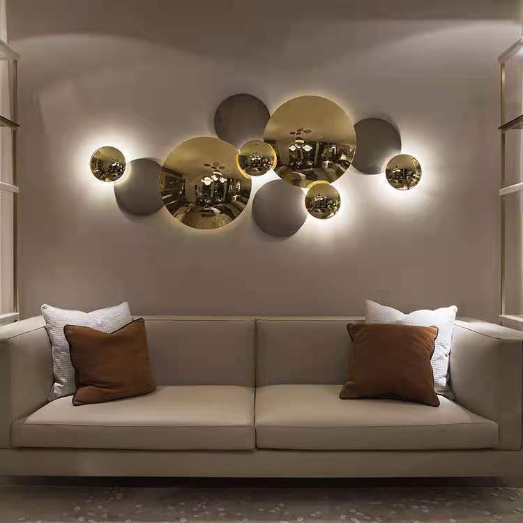 Forart metal wall lamp with mirror-finish spheres illuminating a modern living room