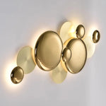 Side glowing angle view of a golden round wall lamp