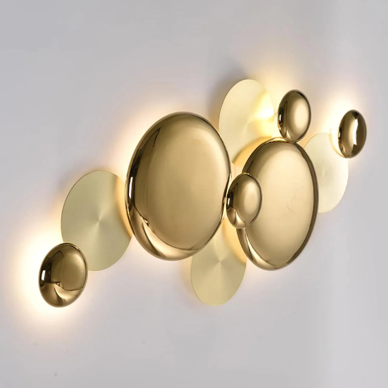 Side glowing angle view of a golden round wall lamp