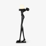 Black humanoid abstract floor lamp with spherical light fixture