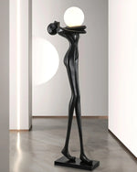 Contemporary black humanoid floor lamp with soft - glowing sphere