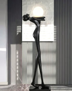 Humanoid - inspired abstract floor lamp with light - emitting globe