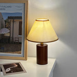 The Japanese Retro Style Table Lamp brights a warmlight near a photo on the table lamp