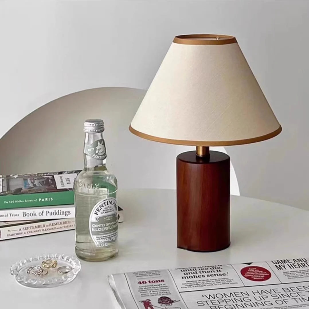 Japanese-style table lamp in cozy reading corner, placed on white round table with newspaper and drink