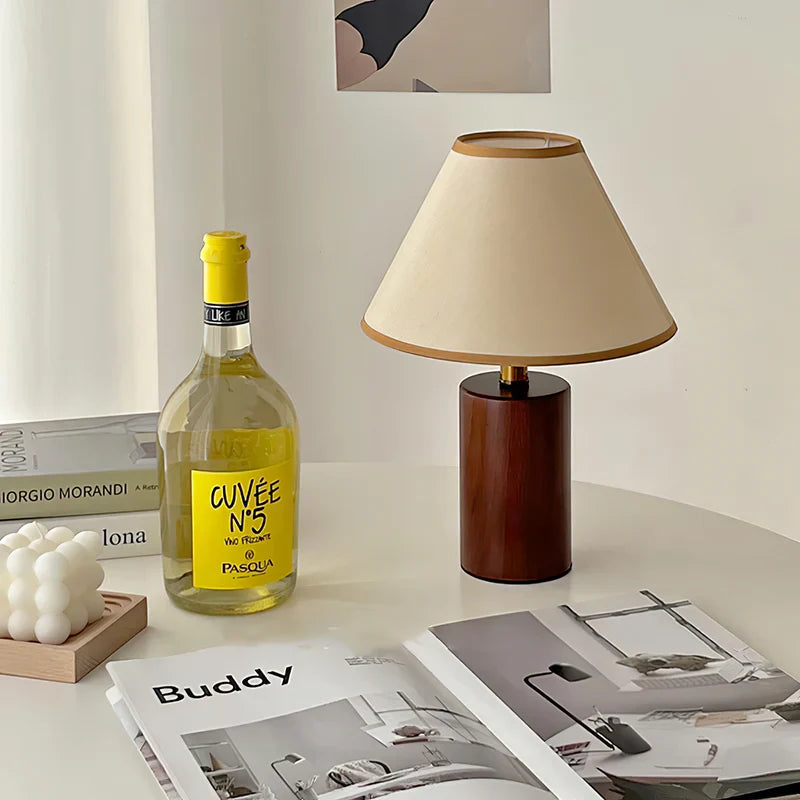 A Japanese_Retro_Style_Table_Lamp_and a bottle are near a magzine