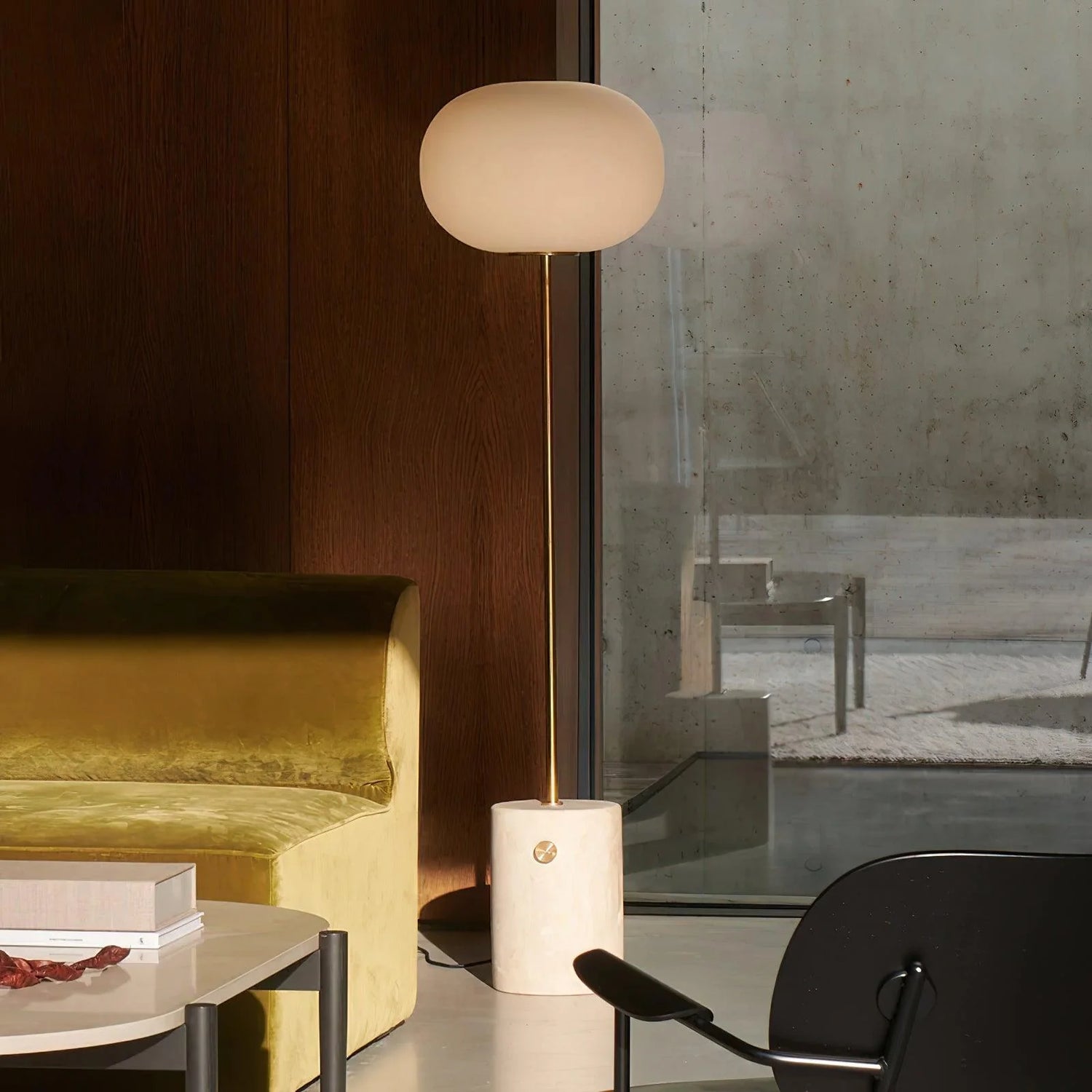 The simple-designed Jwda Glass Floor Lamp is placed in a prominent position in the dark-toned living room