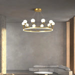 Modern crown chandelier with acrylic accents and white glass globes in a stylish living room.