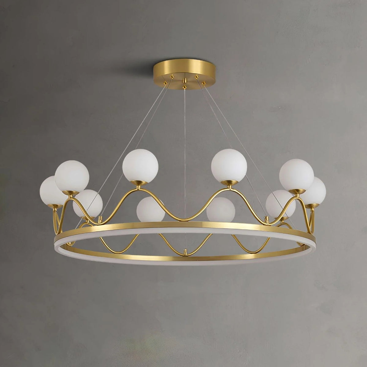 Elegant crown chandelier illuminating a dining area with warm light from white glass globes.