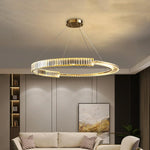 Luxury Toroidal Crystal Chandelier glowing in a modern dining room.