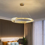 Geometric torus shape chandelier with cascading crystal strands.