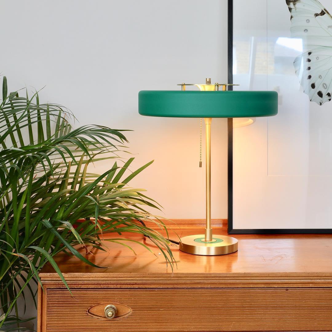 The medium rotary table lamp available in multiple colors like green