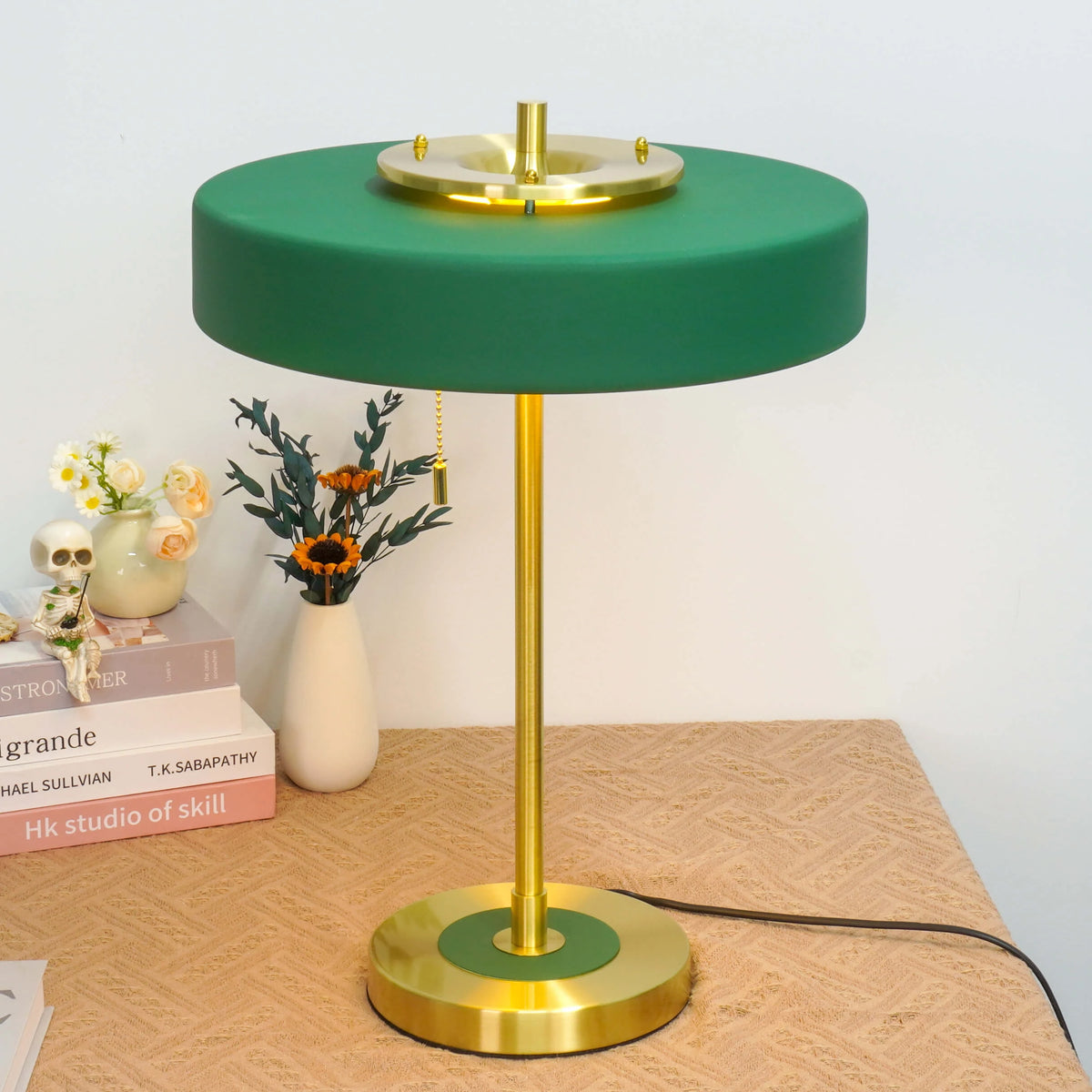 A medium rotary table lamp with a green acrylic shade and gold metal base