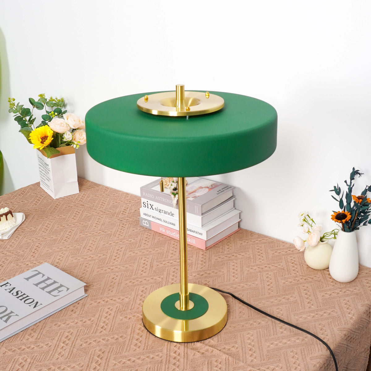 Decorative table lamp with a green acrylic surface and golden metal accents