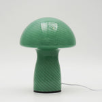 Green mushroom-shaped lamp on a white background