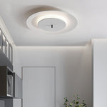On the white ceiling, a simple round ceiling lamp emits soft light.