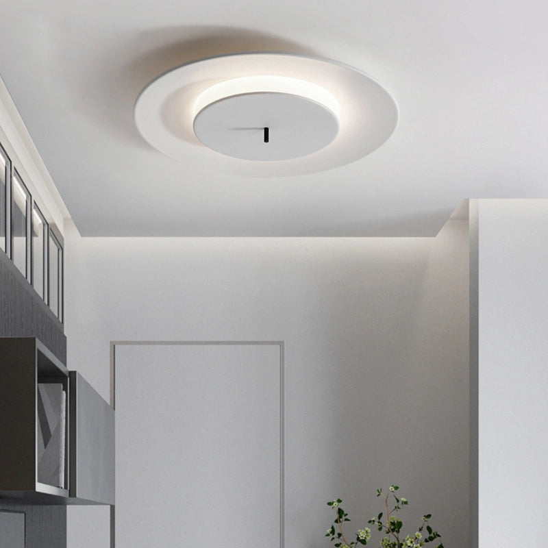 On the white ceiling, a simple round ceiling lamp emits soft light.