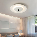In this simple and elegant bedroom, a round ceiling lamp hangs high from the ceiling. The lamp is all white, and the edges emit soft light, illuminating the entire space.