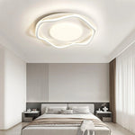 Bedroom shines with a uniquely designed ceiling light, blending art and illumination.
