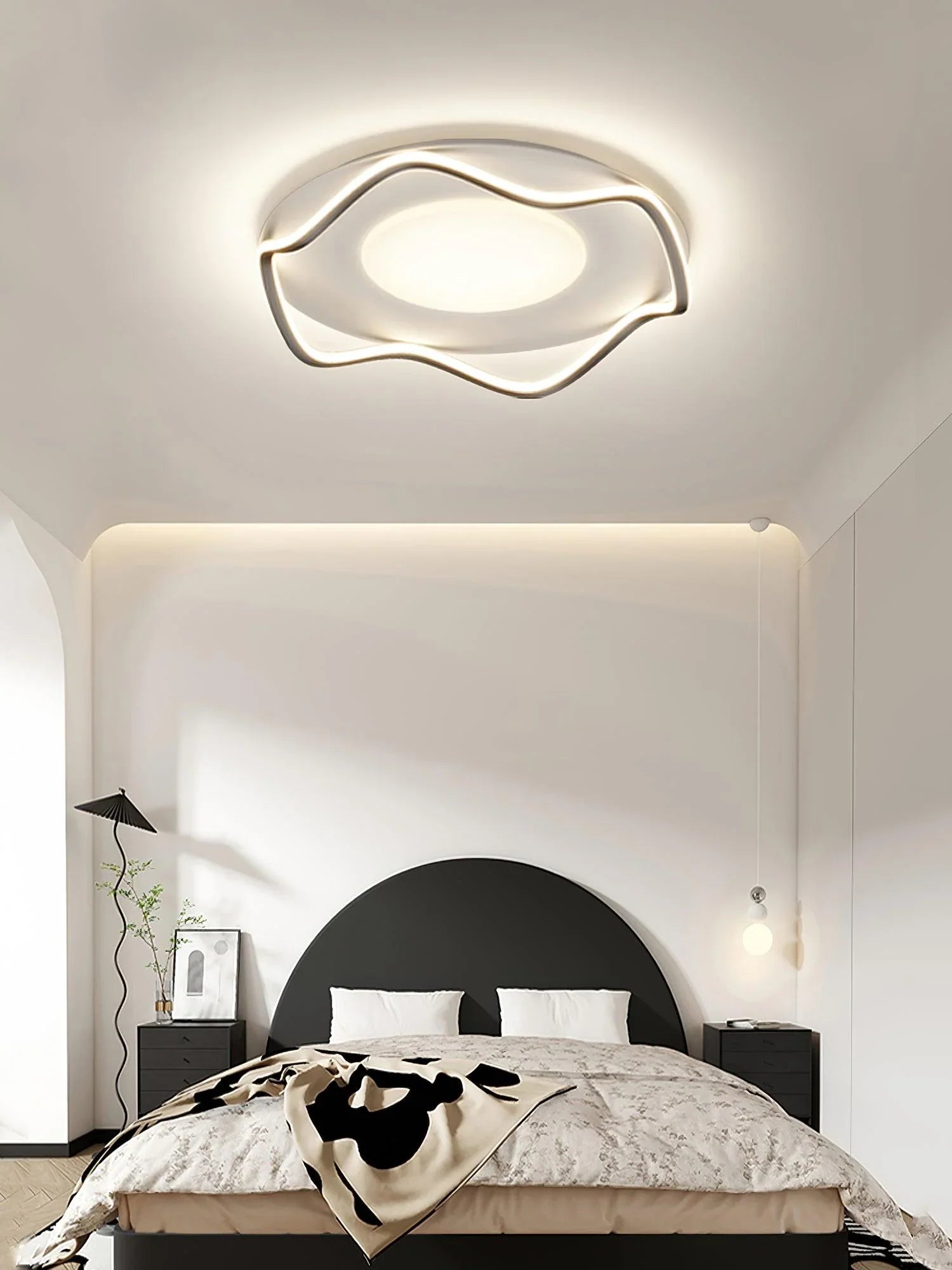 Sleek, curved ceiling fixture casts soft light, elevating the modern bedroom’s aesthetic.