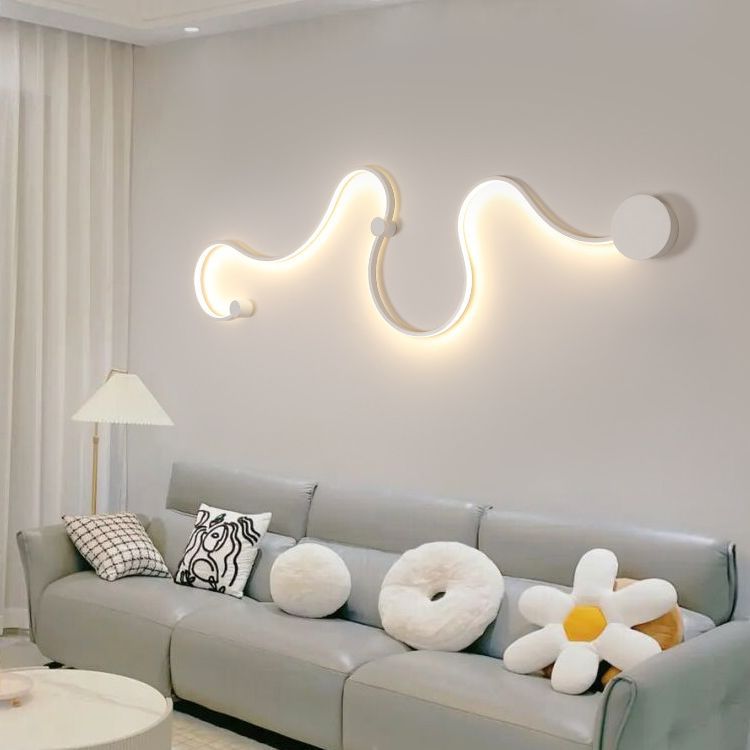 Pair of white serpentine wall lamps flanking a modern art piece in a Scandinavian-style living room.