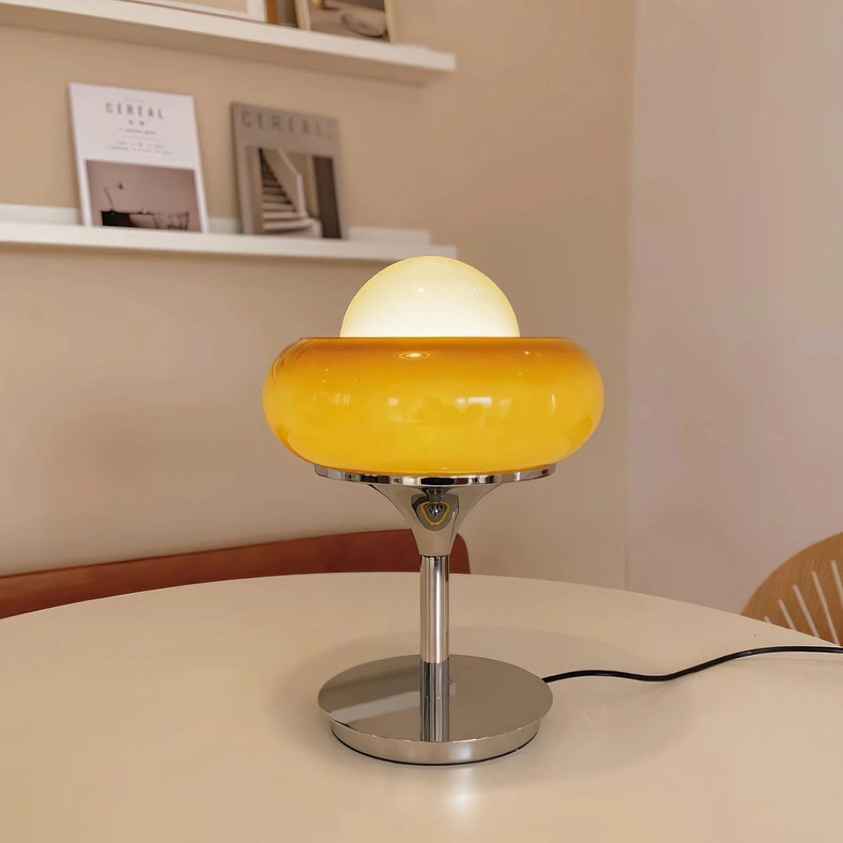 The glass_Table_Lamp_with silver base is on the dining table