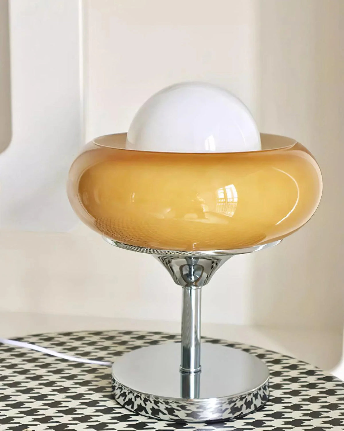 The egg tart shape table lamp is on a dining table in the afternoon