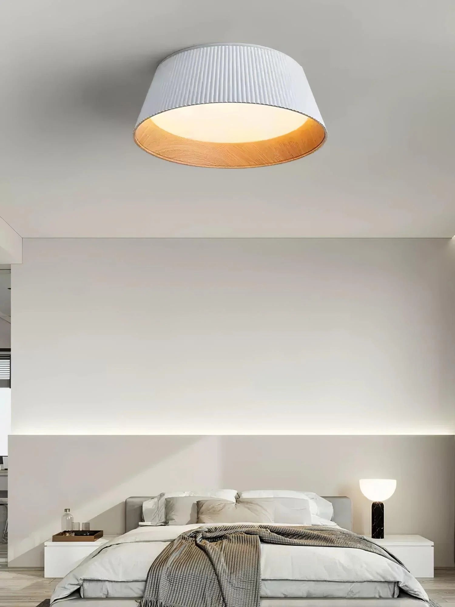 Pleated lamp is in a cozy bedroom