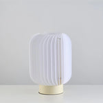 Stylish table lamp uses acrylic and fabric, creating a warm, textured lighting effect.