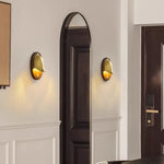 Paired Voss Wall Lamp with brass inner dome casts cozy light along entryway molding